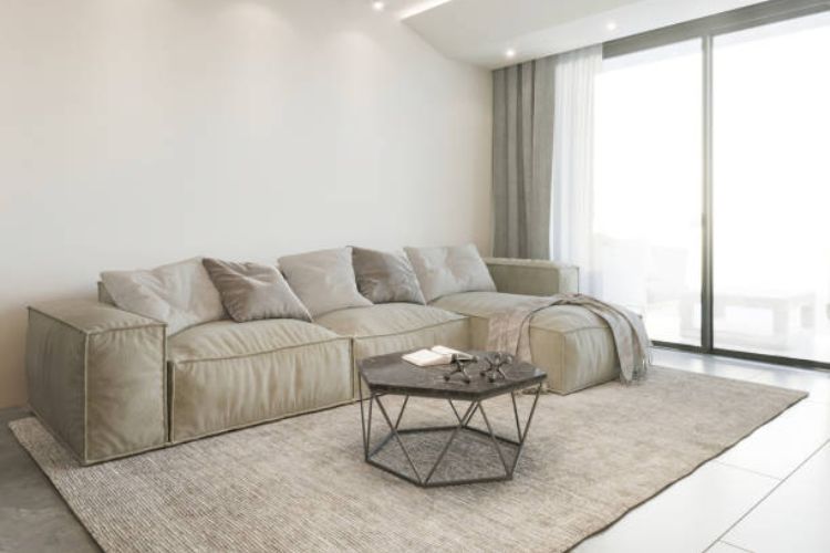 Overview of rug placement process under a sectional